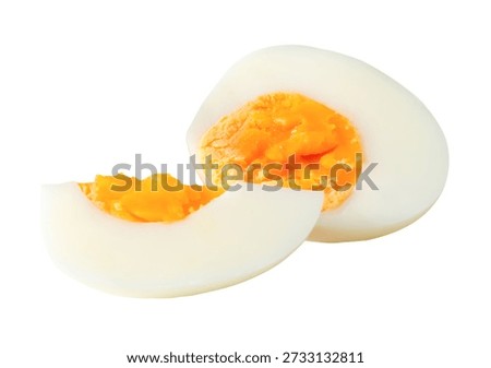 A stack of cooked or boiled unpeeled chicken egg with egg yolk in half and quarter is isolated on white background with clipping path.