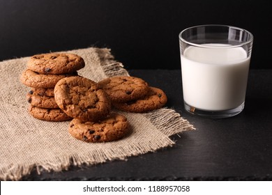 A stack of cookies and a glass of milk on a black background - Powered by Shutterstock