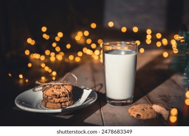 A stack of cookies and glass of milk for Santa on wooden background, concept Christmas and holiday - Powered by Shutterstock