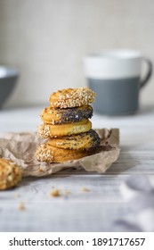 A stack of cookies on paper. The background is blurred. On a white wooden background