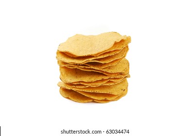 A stack of corn tortilla shells on white