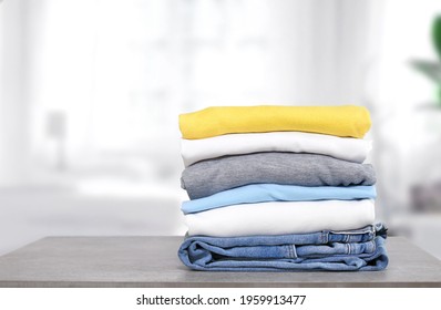 Stack of cotton colorful clothes on table indoors.Stacked apparel.Folded clean clothing.Household.