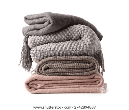 Stack of cozy blankets on white background