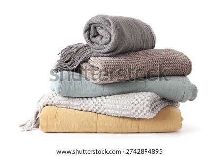 Stack of cozy blankets on white background