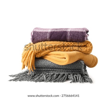 Stack of cozy blankets on white background