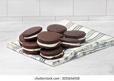 A Stack Of Cream Filled Chocolate Cookies.