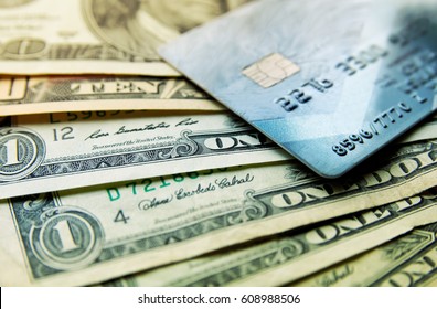 Stack of credit american dollars cash and credit card, close-up macro view.