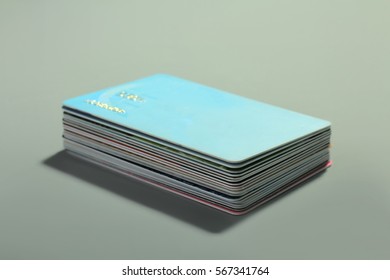 Stack of credit cards on a gray background.