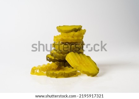 stack of crinkle cut dill pickle chips isolated in white background