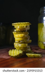 Stack Of Crinkle Cut Pickle Chips In Dark Background