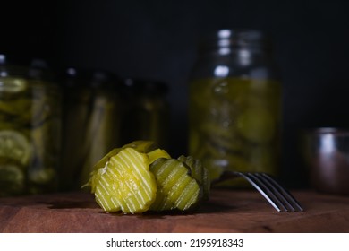 Stack Of Crinkle Cut Pickle Chips In Dark Background