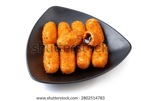 Stack of crispy fried glutinous rice cakes with oozing black brown sugar filling in a plate