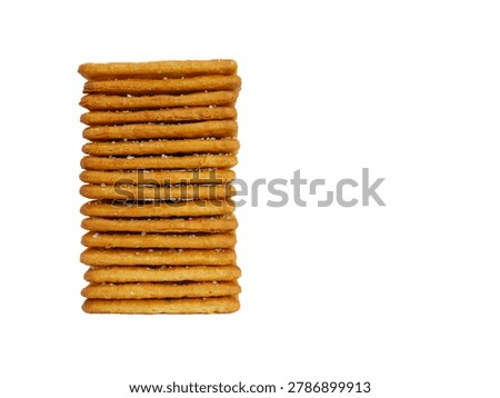 Stack of crispy square crackers isolated on white background. High stack of golden brown biscuits with copy space on the right.