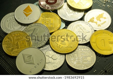 Stack of cryptocurrencies, Golden coins with bitcoin symbol on a mainboard.