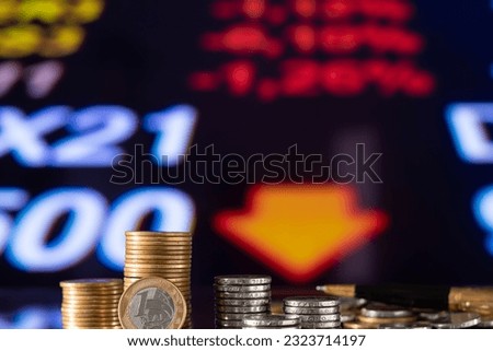 stack of currencies on a graph, concept of economic collapse, falling financial graph, falling stock market, inflation, financial crisis, falling GDP income, capital reduction