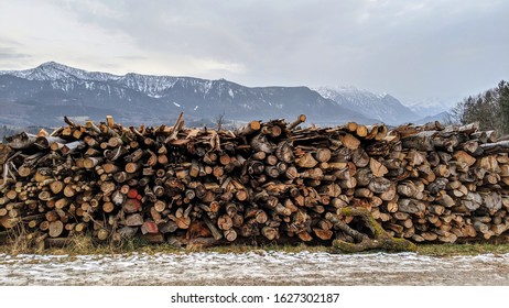 Stack of cut wood on mountain backdrop timer in winter sawed log outdoor stack woodpile