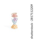 Stack of cute pink tea cup teapot and colorful checkered mug in a fun whimsical pixel art style design