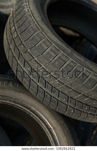 Stack Of\
Damaged Tires, old car tires at a scrap\
yard