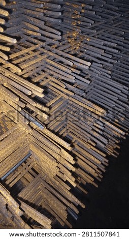 A stack of deformed steel bars arranged into mats or prefabricated frameworks, such as wire mesh or 