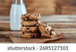 Stack of Delicious Chocolate Chip Cookies with Fresh Milk on Rustic Wooden Table