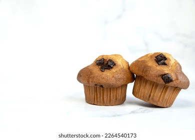 A stack of delicious chocolatechip banana muffins and blueberries on a white background, tasty healthy snack granola breakfast muffin food