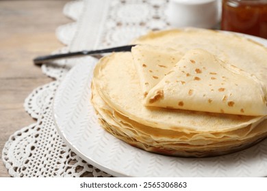 Stack of delicious crepes on table, closeup