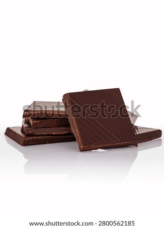 Stack of delicious dark chocolate squares on white