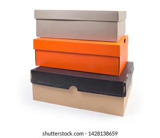 Stack of different closed cardboard shoes boxes various colors on a white background