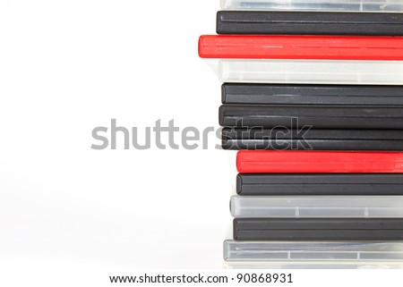 Stack of different colored DVD cases in front of a white background