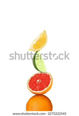 Stack of different fresh citrus fruits on white background