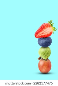 Stack of different fresh tasty berries on cyan background, space for text