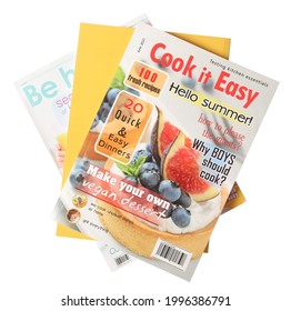 Stack of different magazines on white background, top view