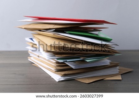 Stack of different paper envelopes on wooden table, closeup. Post office
