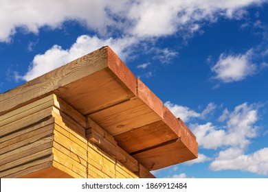 Stack of dimensional lumber for home construction with partly cloudy sky.  - Shutterstock ID 1869912484