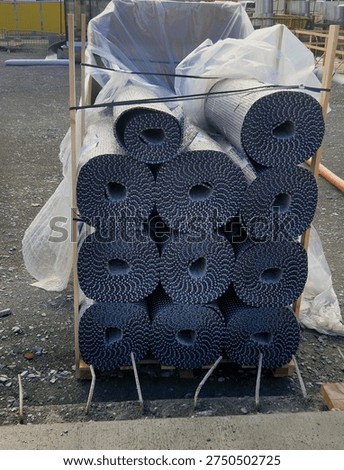 stack of dimpled drainage membrane often called Platon or Egg crate membrane. used for foundation protection or sub-floor drainage.construction site, this material is high-density polyethylen HDPE sheet used to keep moisture away from structural walls.