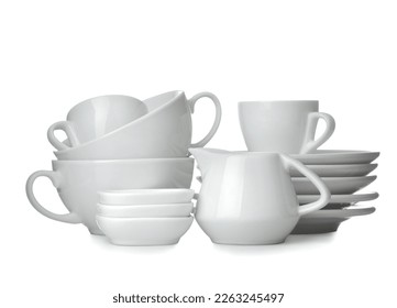 A stack of dishes. Dinnerware. plates, kettle and cup on a white isolated background. close-up.