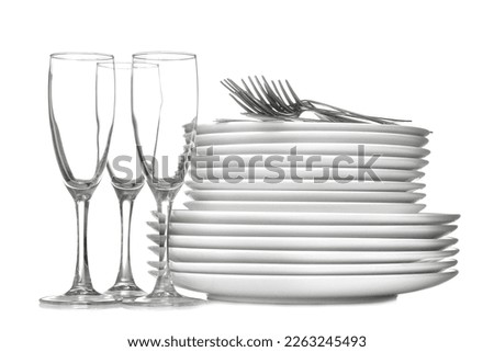 A stack of dishes. Dinnerware. plates, kettle and cup on a white isolated background. close-up.