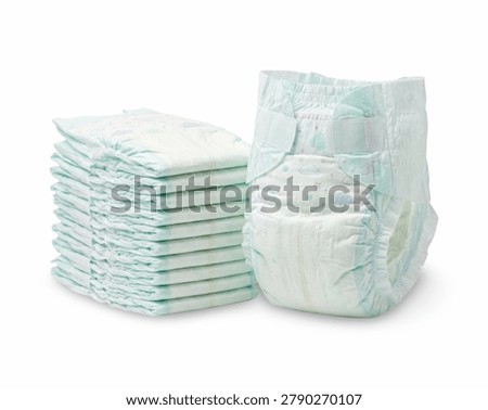 Stack of disposable baby diapers next to an open diaper isolated on a white background