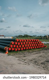 Stack Of District Heating Pipes On The Grass. Sustainable Heat For Eco Friendly Houses In The Netherlands.   