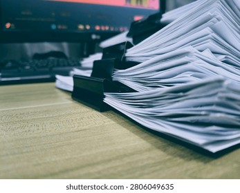 Stack of Documents and Binder Clips on Office Desk
