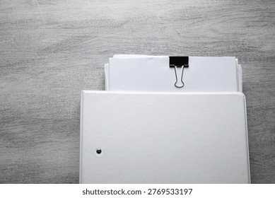 Stack of documents on the table.