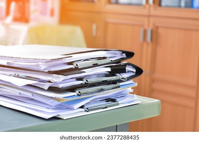 Stack of documents on table of secretary, sunlight edited, soft and selective focus.