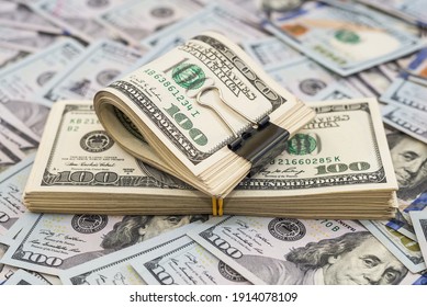 Stack of dollars and dollars with a metal clip on the money background. Lots of bills. - Shutterstock ID 1914078109