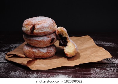 A stack of donut with melted chocolate inside