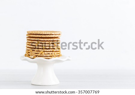 Stack of Dutch caramel waffles
dutch stroopwafel, waffle on a mini white cake stand with copy space on right