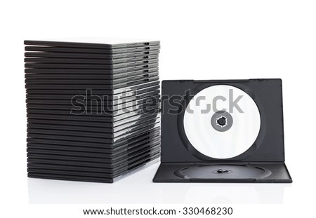 Stack of dvd boxes with disc on white background