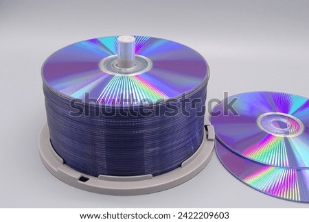  a stack of dvd's in front of a grey background                              