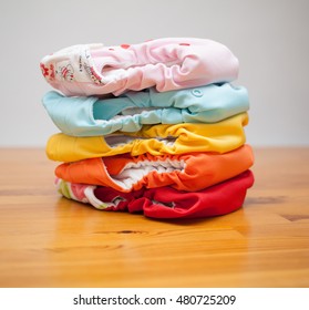 Stack Of Eco Cloth Diapers On A Wooden Table