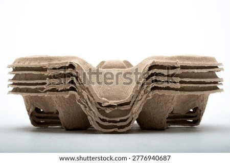 Stack of eco-friendly brown pulp paper coffee cup holders for two drinks, isolated on white background. Perfect for take away beverage delivery and sustainable food service branding.