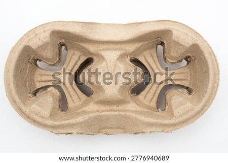Stack of eco-friendly brown pulp paper coffee cup holders for two drinks, isolated on white background. Perfect for take away beverage delivery and sustainable food service branding.